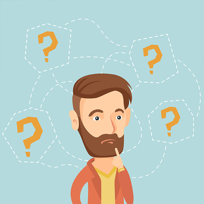 Pondering man surrounded by question marks